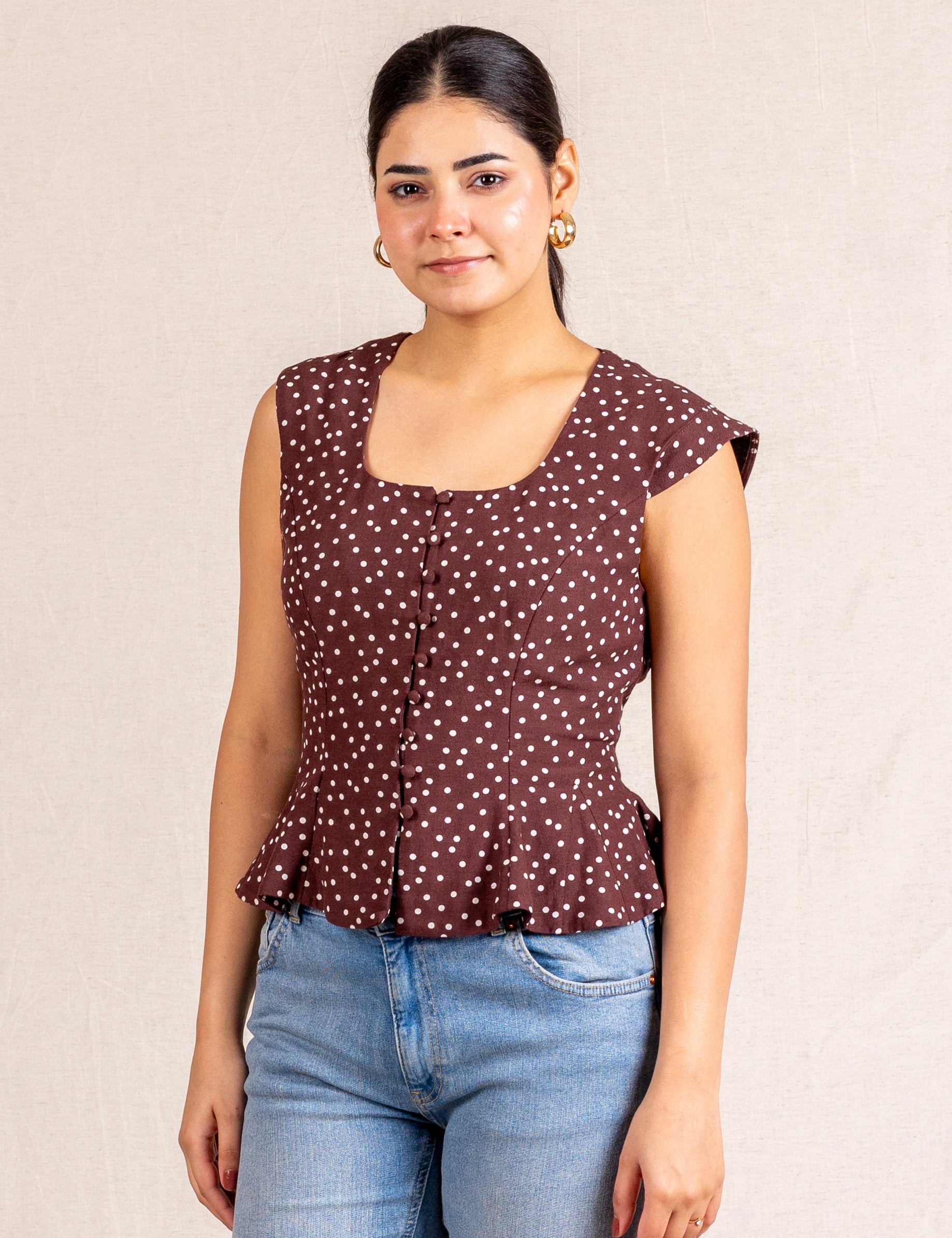 Brown polka dot peplum sleeveless top