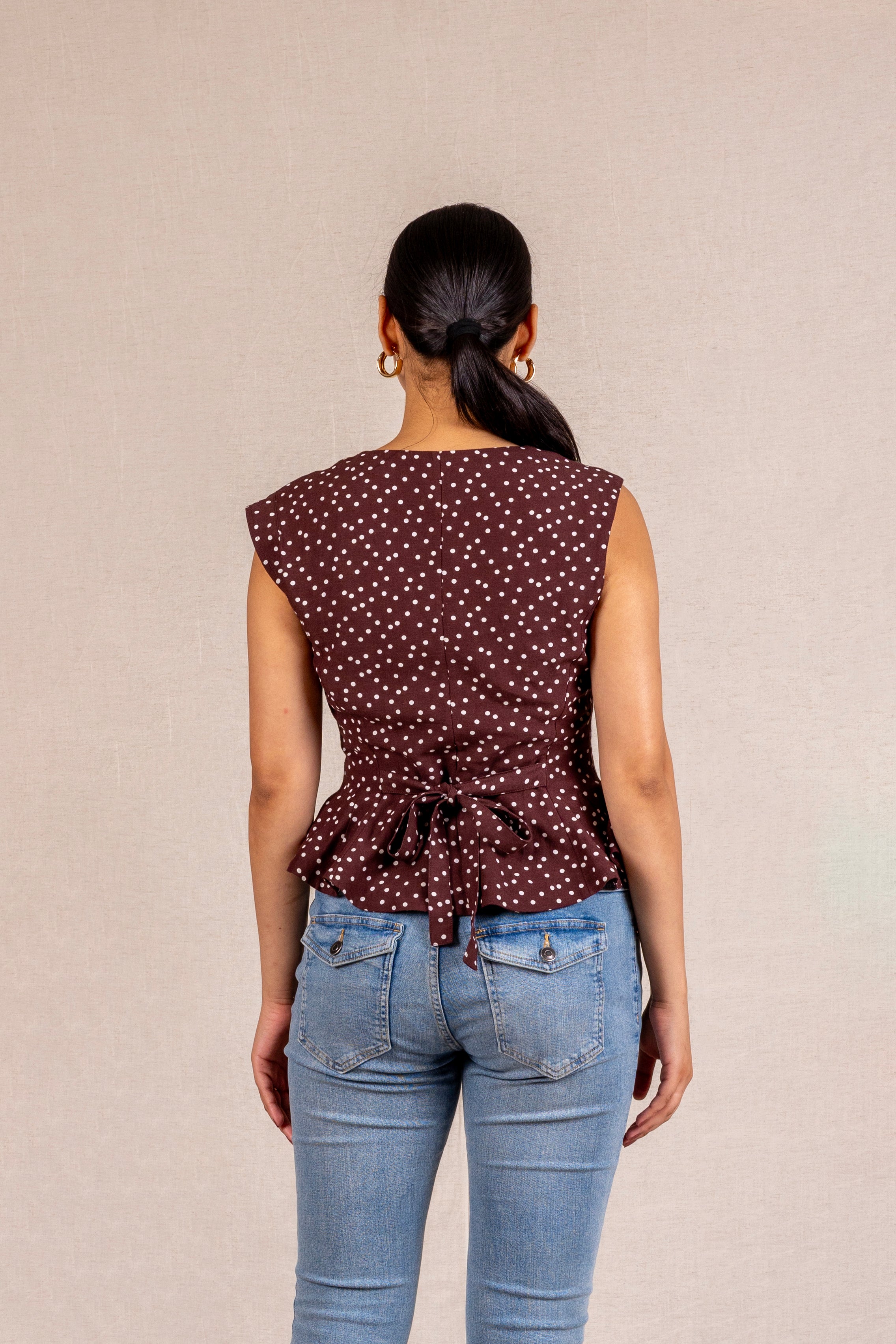 Brown polka dot peplum sleeveless top