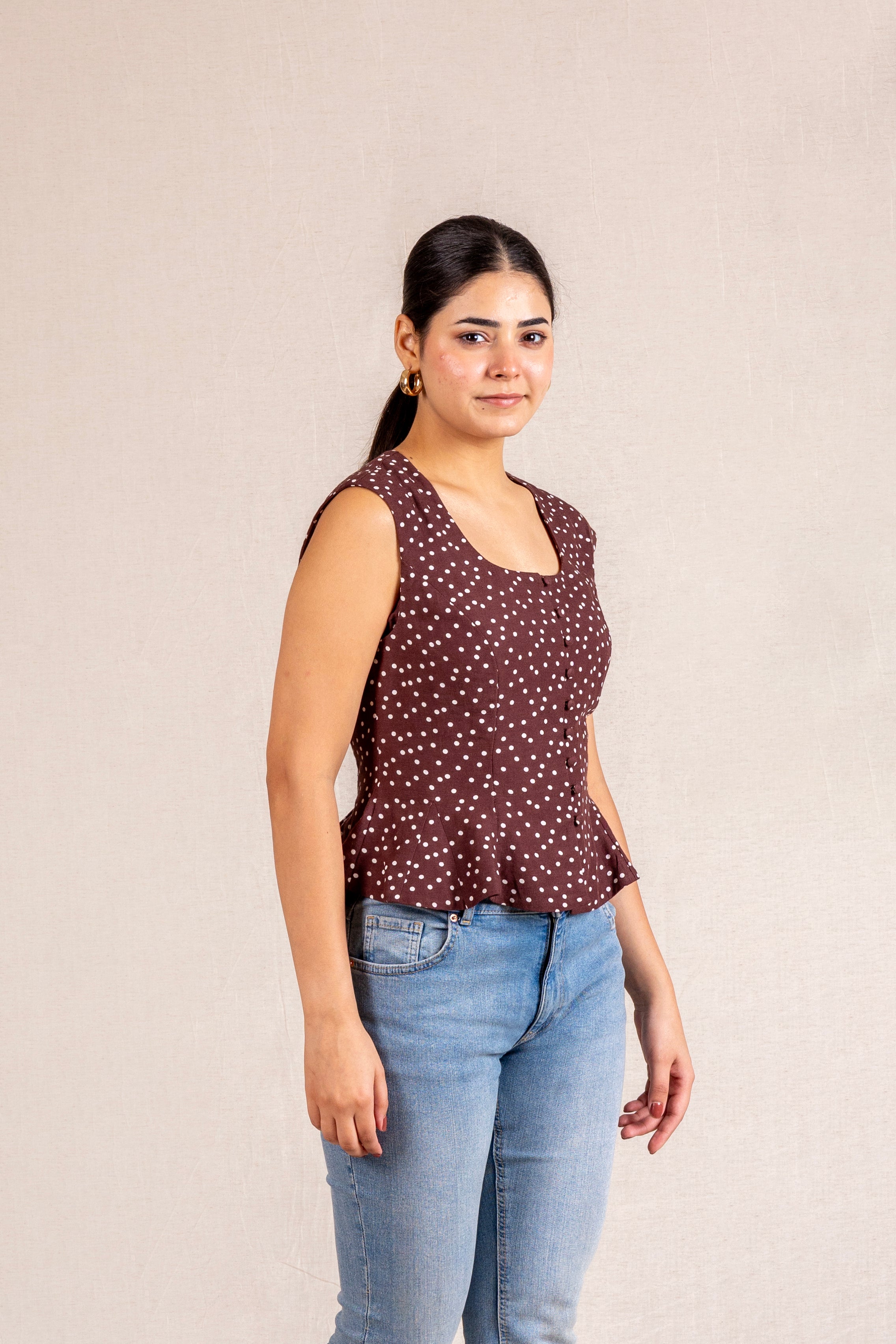 Brown polka dot peplum sleeveless top