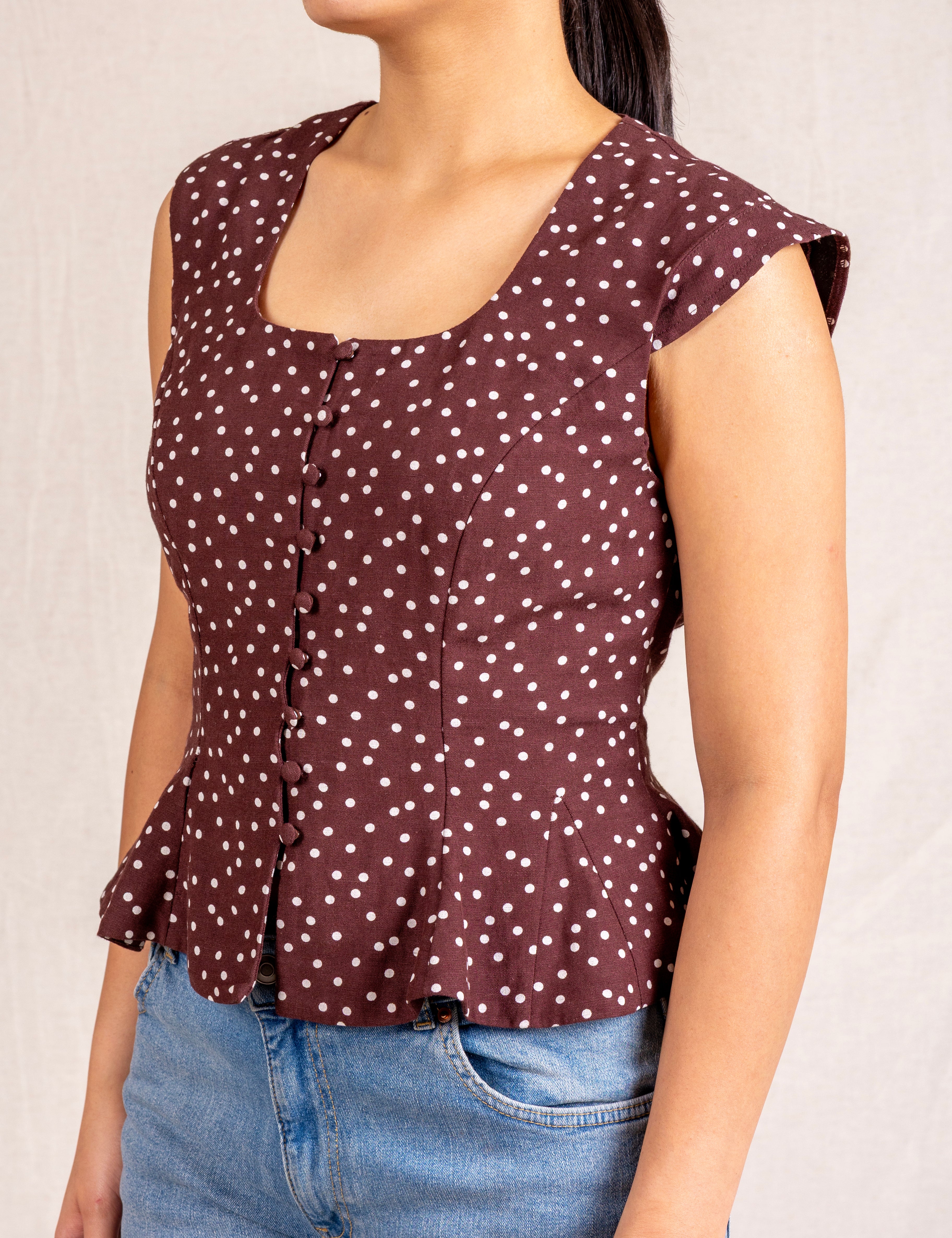 Brown polka dot peplum sleeveless top